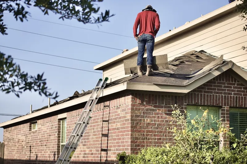 Professional roofer working on a residential roof in East Hauppauge